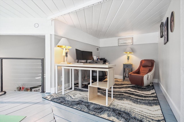 living room featuring baseboards, wood finished floors, visible vents, and wooden ceiling