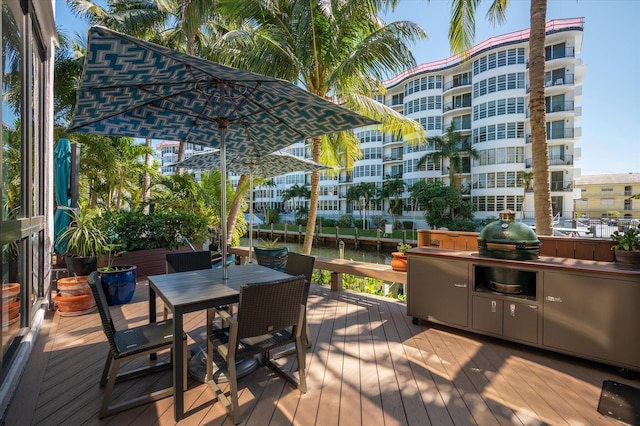 wooden deck featuring outdoor dining area and grilling area