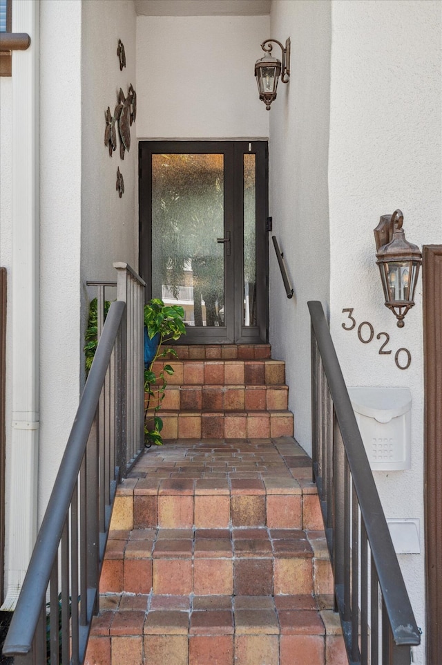 property entrance featuring stucco siding