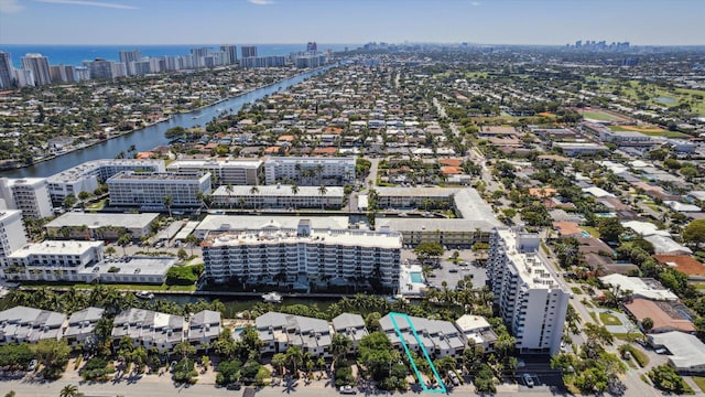 drone / aerial view featuring a view of city and a water view