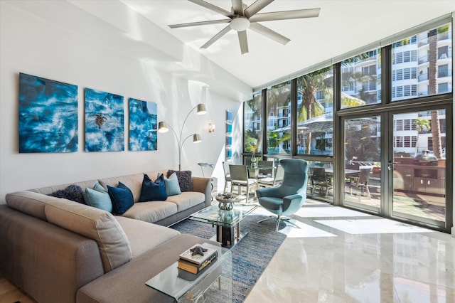 living room with lofted ceiling, floor to ceiling windows, a ceiling fan, and marble finish floor