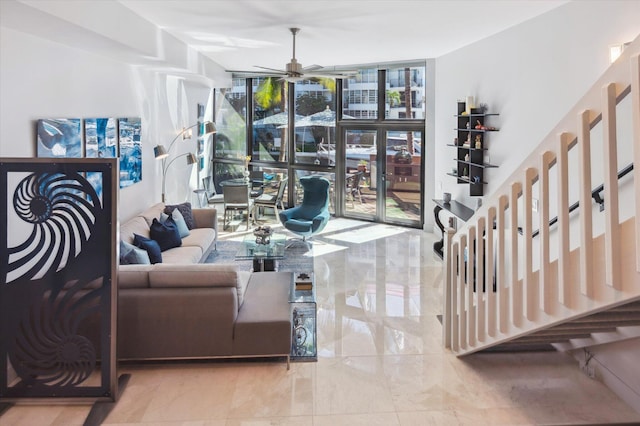 living room featuring a wall of windows, marble finish floor, and ceiling fan