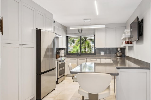 kitchen with a sink, open shelves, stainless steel counters, backsplash, and stainless steel appliances