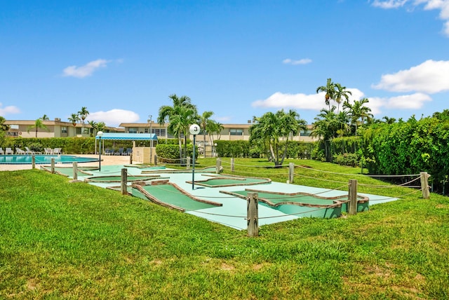 view of property's community featuring a pool and a yard