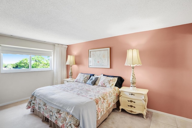 bedroom featuring tile patterned flooring, baseboards, and a textured ceiling