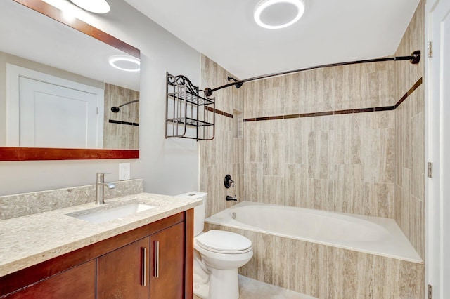 full bathroom with toilet, tile patterned flooring, tiled shower / bath, and vanity