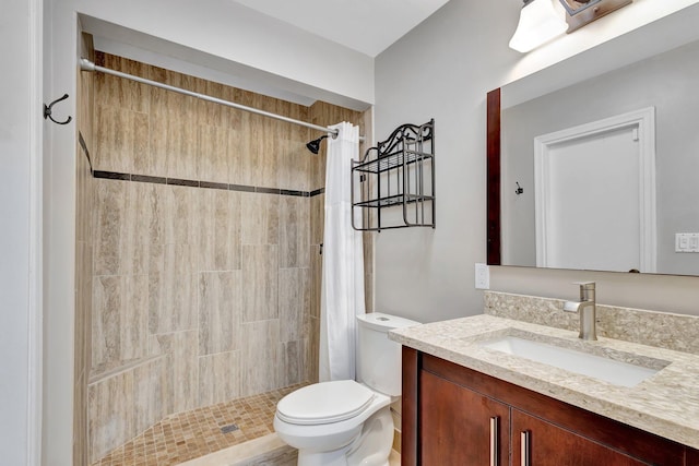 full bath with toilet, a stall shower, and vanity