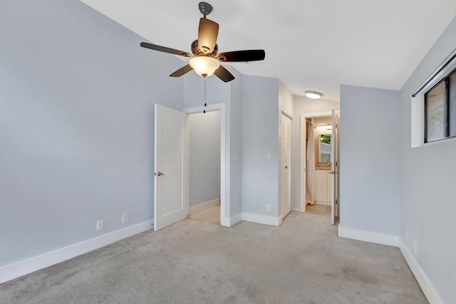 unfurnished bedroom featuring carpet floors, a ceiling fan, and baseboards