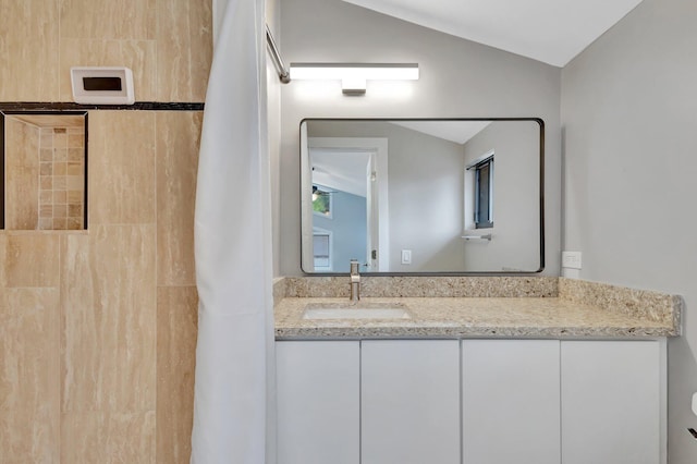 full bathroom featuring curtained shower, vaulted ceiling, and vanity