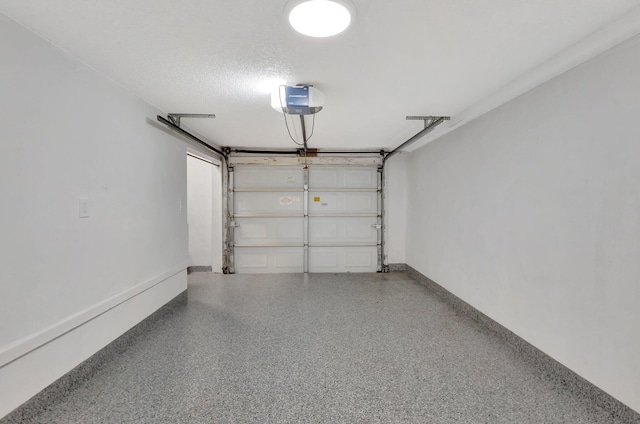 garage with a garage door opener and baseboards