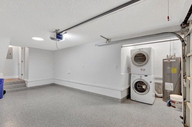 laundry room featuring a garage, stacked washer and dryer, laundry area, and electric water heater