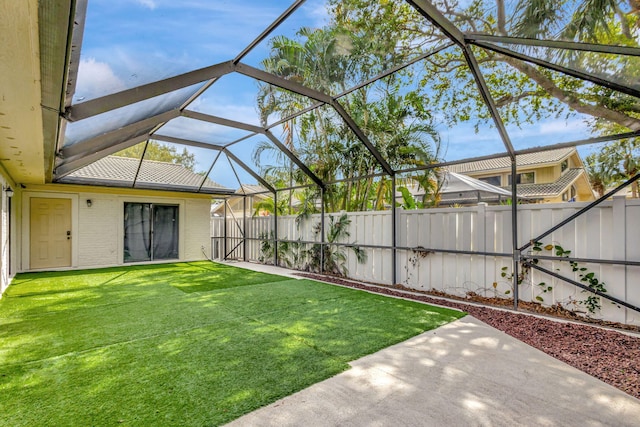 view of yard featuring glass enclosure, a patio area, and a fenced backyard