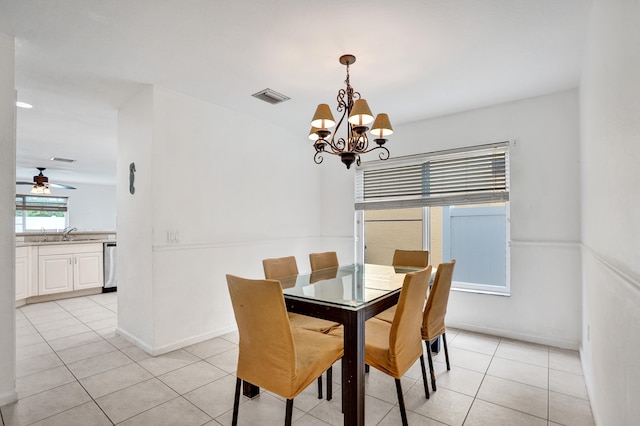 dining space with ceiling fan with notable chandelier, visible vents, baseboards, and light tile patterned flooring