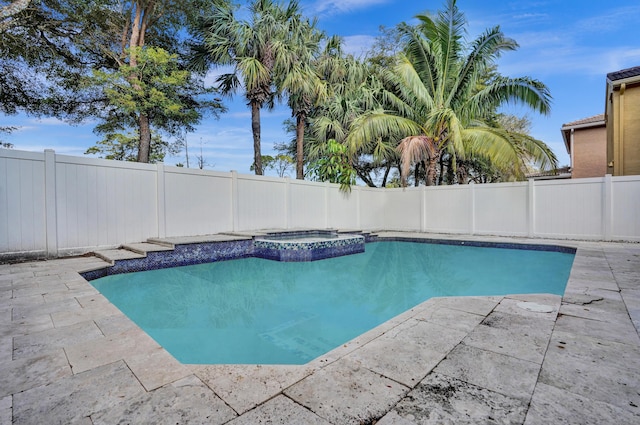 view of swimming pool with a patio, a fenced backyard, and a pool with connected hot tub