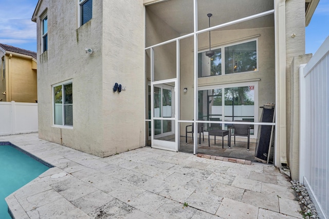 back of property with a patio area, a fenced backyard, and stucco siding