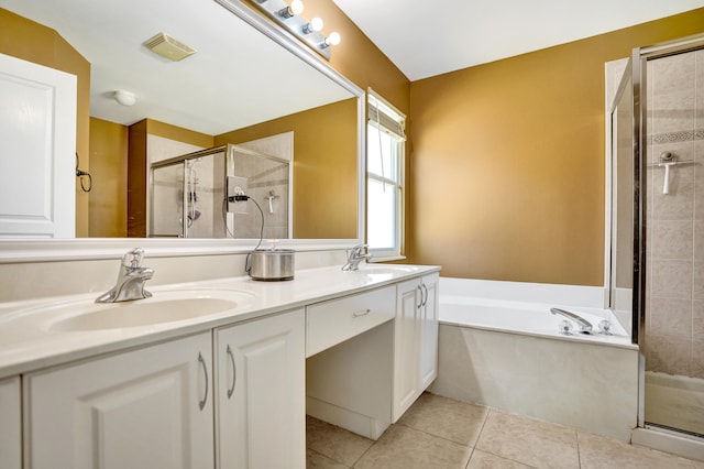 bathroom with double vanity, a stall shower, tile patterned flooring, and a sink