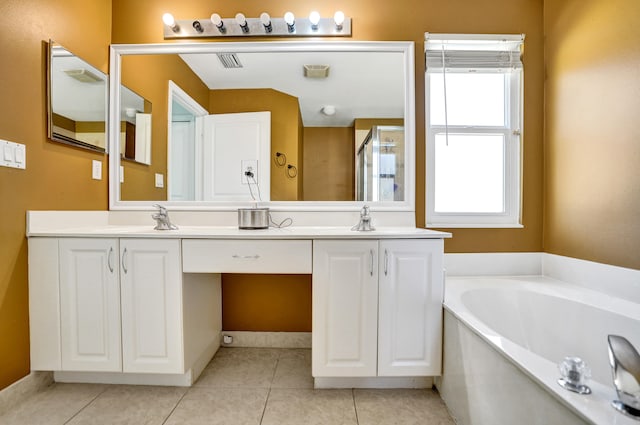 bathroom with a garden tub, double vanity, tile patterned flooring, and a sink