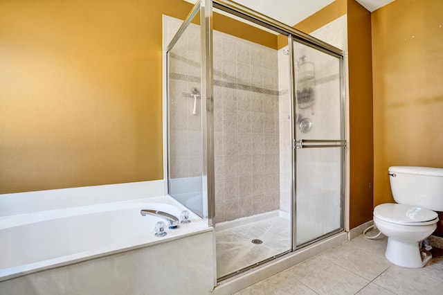 bathroom featuring toilet, a shower stall, a bath, and tile patterned floors