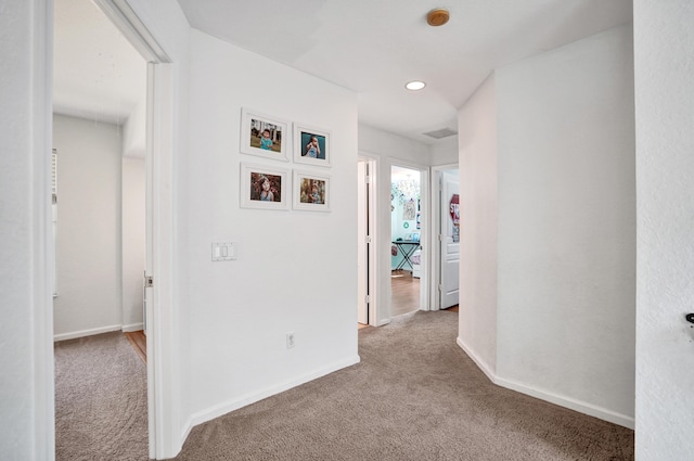 hall featuring carpet floors, recessed lighting, and baseboards