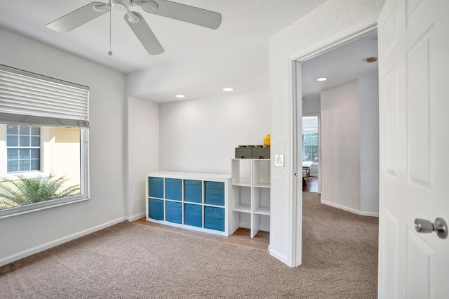 carpeted empty room with a ceiling fan, recessed lighting, a healthy amount of sunlight, and baseboards