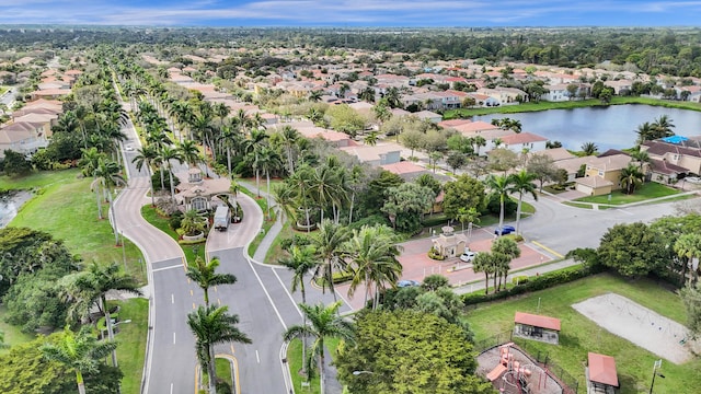 drone / aerial view featuring a residential view and a water view