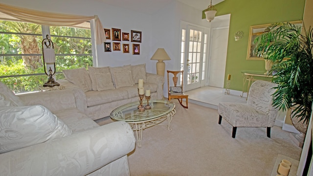 tiled living room with lofted ceiling, a wealth of natural light, and carpet floors