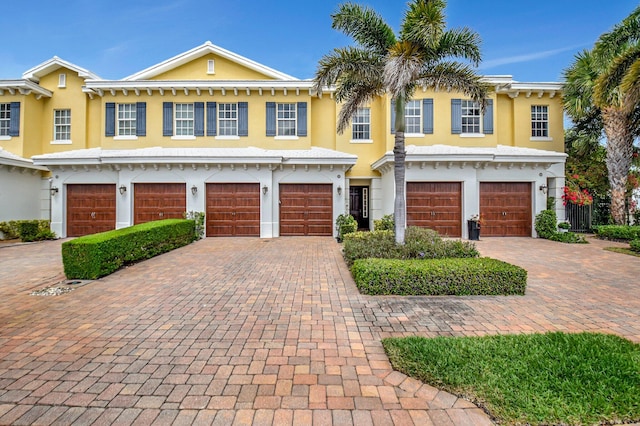 view of front facade featuring driveway, an attached garage, and stucco siding