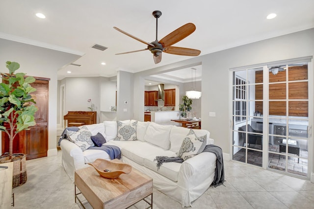 living room featuring light tile patterned floors, visible vents, ceiling fan, crown molding, and recessed lighting