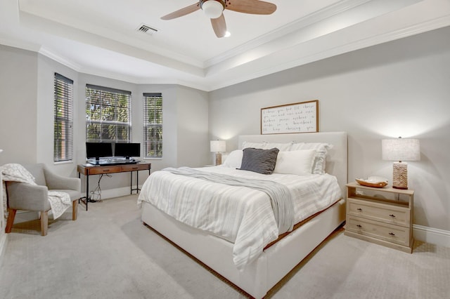 carpeted bedroom with baseboards, visible vents, a raised ceiling, a ceiling fan, and ornamental molding