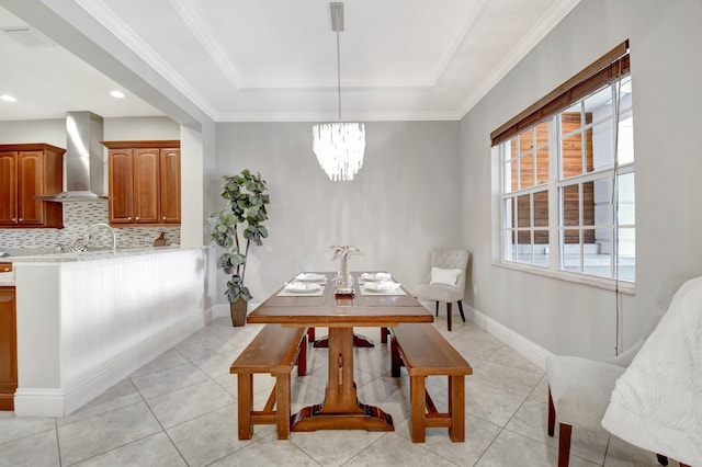 dining space featuring baseboards, a tray ceiling, light tile patterned floors, and a healthy amount of sunlight