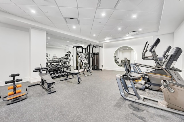 exercise room featuring recessed lighting, visible vents, a paneled ceiling, and baseboards