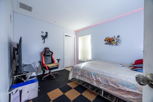 bedroom featuring visible vents and baseboards