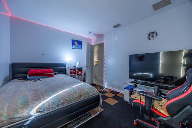 bedroom featuring visible vents and tile patterned floors