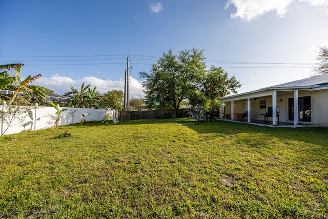 view of yard featuring a patio and fence