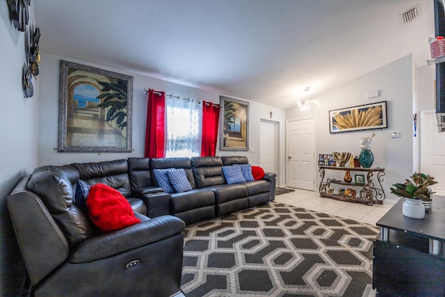 tiled living room with visible vents and vaulted ceiling