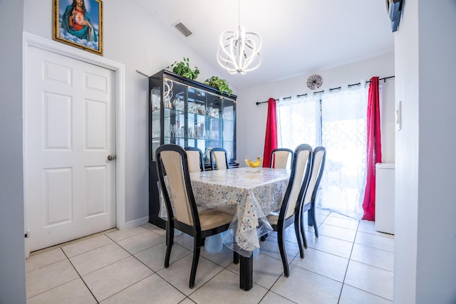 dining area featuring lofted ceiling, light tile patterned floors, visible vents, and a notable chandelier