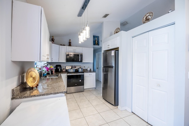 kitchen featuring appliances with stainless steel finishes, a sink, visible vents, and white cabinets