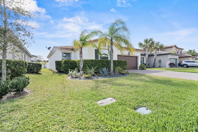 view of front of home with an attached garage, a front yard, decorative driveway, and stucco siding