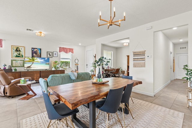 dining space featuring baseboards, visible vents, and light tile patterned flooring