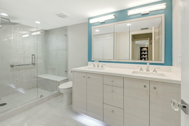 bathroom with toilet, a sink, visible vents, and a shower stall