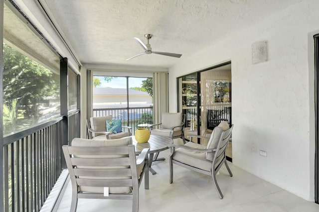 sunroom / solarium with a ceiling fan