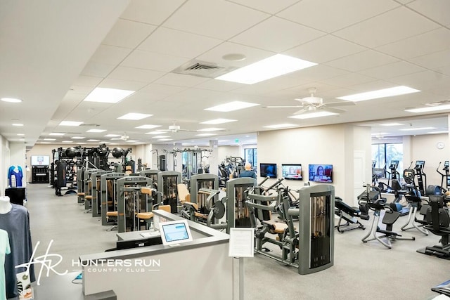 exercise room featuring a paneled ceiling, visible vents, and a ceiling fan