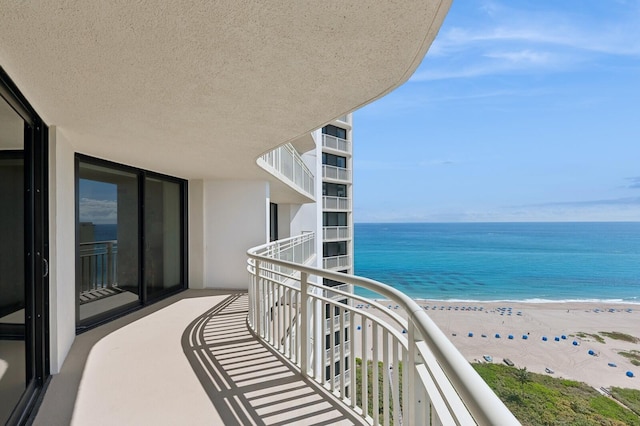 balcony with a view of the beach and a water view