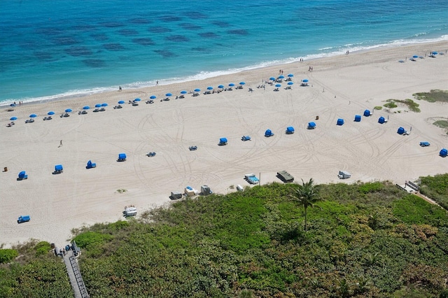 aerial view with a water view and a view of the beach