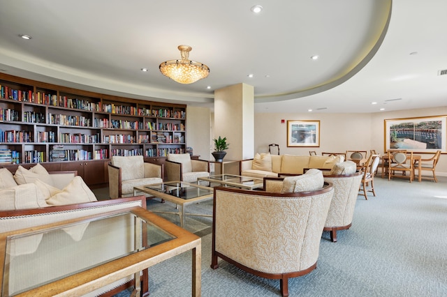 interior space with carpet floors, recessed lighting, a raised ceiling, and visible vents