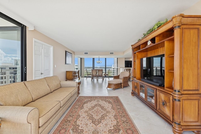 living room featuring light tile patterned floors and a wall of windows