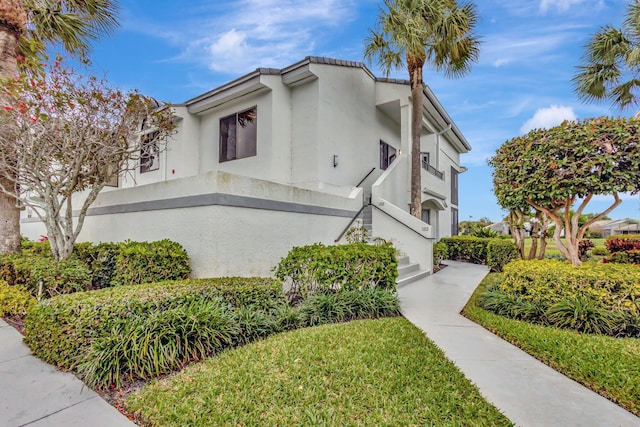 view of side of property featuring stucco siding