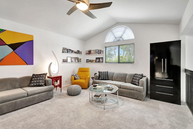 living area featuring vaulted ceiling, ceiling fan, and carpet flooring