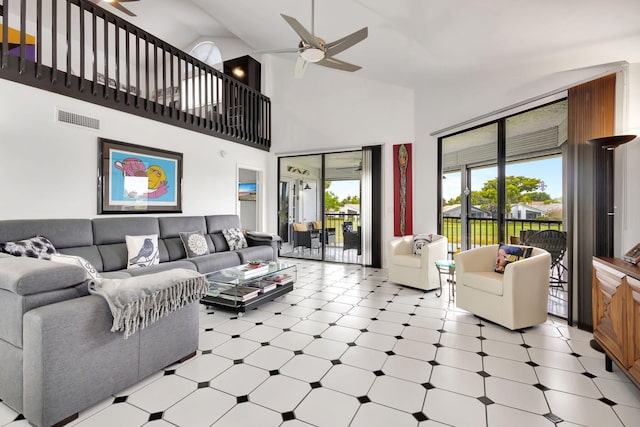 living area with light floors, ceiling fan, visible vents, and high vaulted ceiling