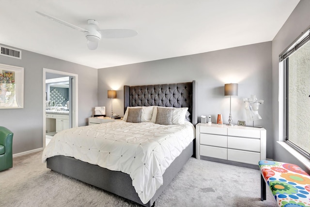 bedroom with baseboards, visible vents, a ceiling fan, ensuite bathroom, and carpet floors